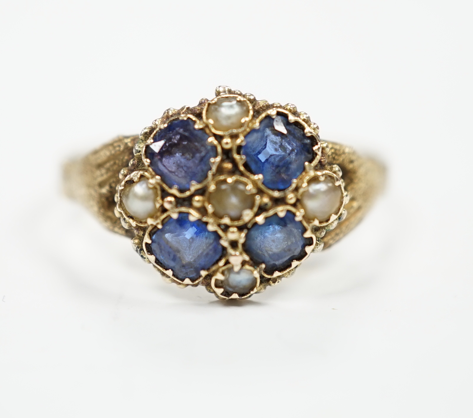 A Victorian 12ct gold sapphire and seed pearl cluster set ring, size M, gross weight 1.6 grams.